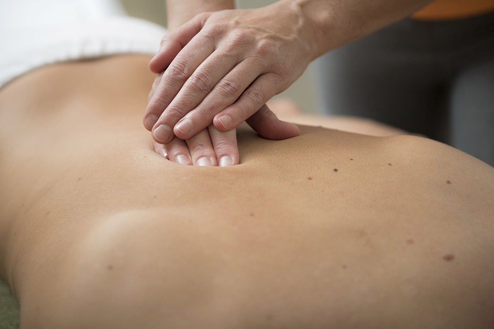 Woman massaging clients back